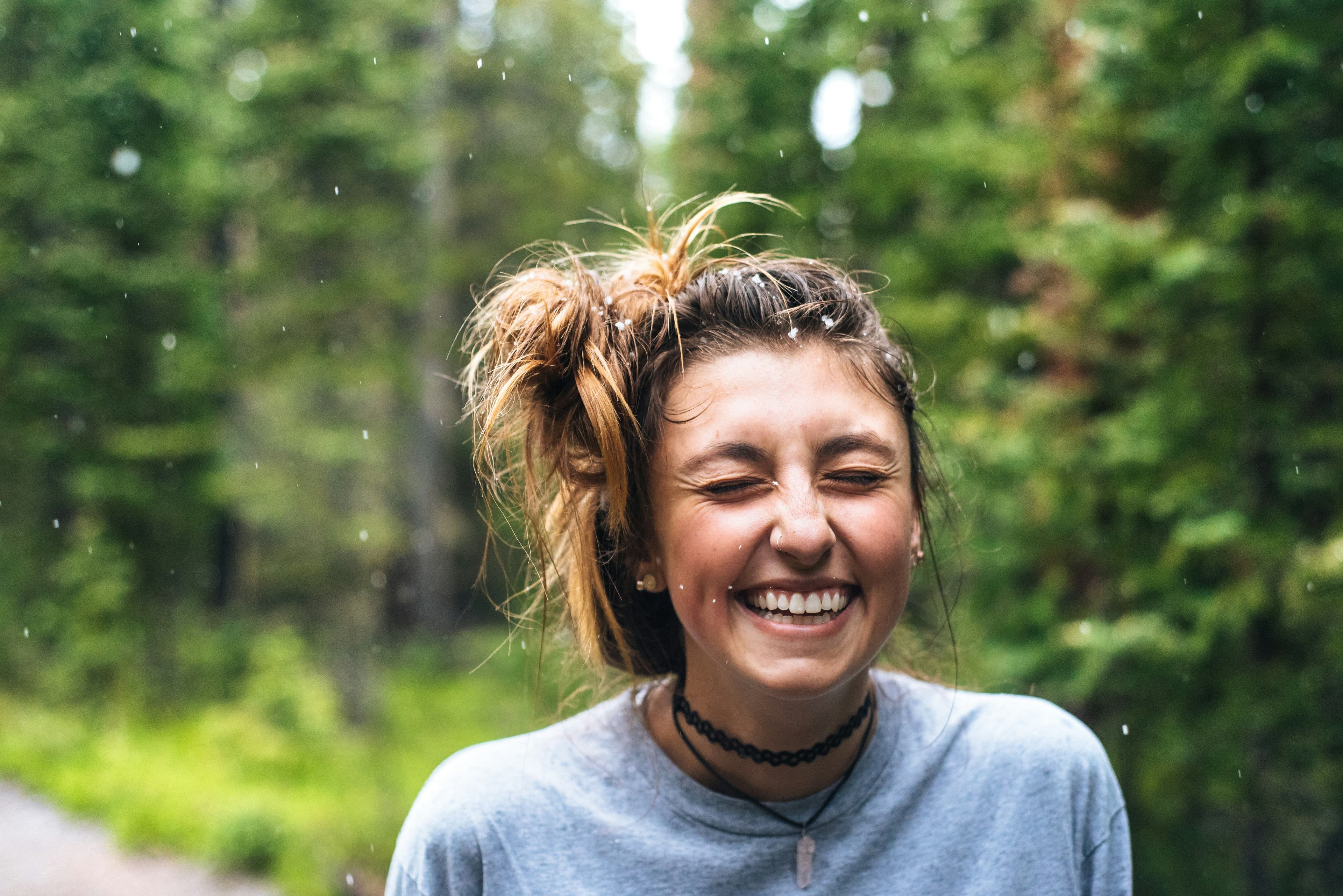 A person laughing joyfully outdoors